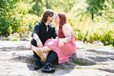 Candid garden engagement session at Acton Arboretum featuring natural greenery and emotion.