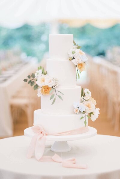 An elegant white cake with sugar flowers