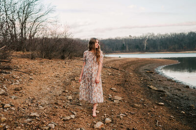 Branson Missouri senior photography of teen girl looking at lake walking on rocks