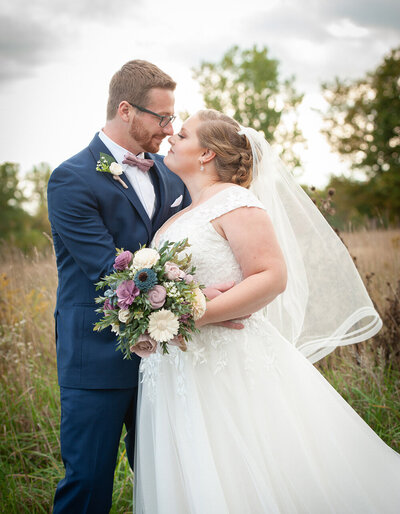 bride and groom touching noses together