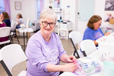 Volunteer preparing knitted and crocheted memory keepsakes for miscarriage and pregnancy loss 