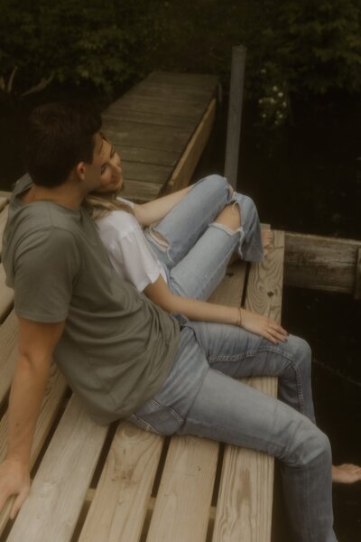 A couple relaxes together on a pond dock in Iowa.