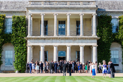 The entire wedding party enjoying a wedding day at Goodwood House at the end of the summer season
