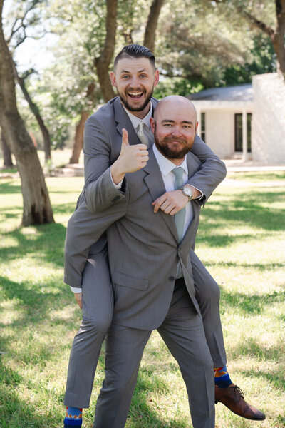 grooms takes funny picture with best man during wedding speech