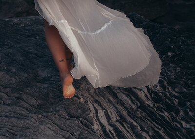 woman-wearing-white-dress-walking-on-sand-2029253
