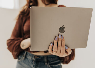 woman holding laptop