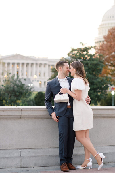 Couple taking engagement photos in front of the US Capitol Building. Taken by Washington DC Wedding Photographer Bethany Aubre Photography.