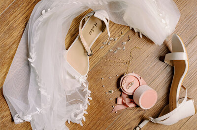 Flat lay of bridal accessories including shoes, veil, jewelry, and ring box, styled and photographed by Joseph Mayden to capture elegant wedding day details.