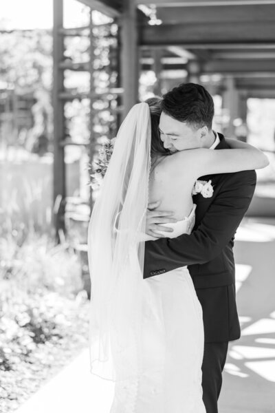 bride and groom hugging on their wedding day