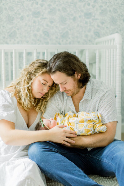 Mother and Father holding newborn baby in Green Bay, WI