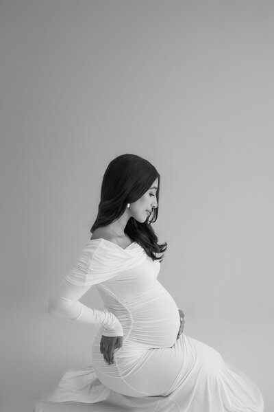 maternity photo shoot in all white studio mom with baby bump