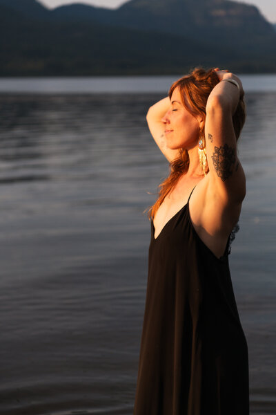 yoga teacher gazing out at the river