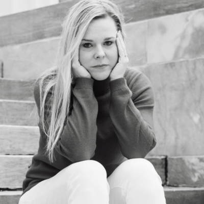 Black and white photo of woman sitting alone crying