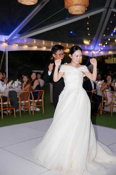 a wedding couple dancing together during their wedding reception 