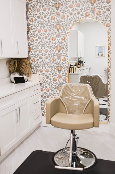 leather salon chair sitting in hair salon with flower wall paper