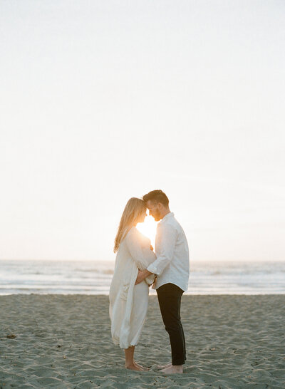 Bride and groom sharing a romantic kiss in the lush vineyards at Cayman Winery, a stunning Bay Area wedding venue.
