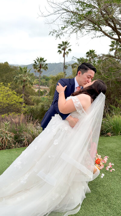 Bride and groom kissing during portraits at the San Diego Safari Park in Escondido, California.