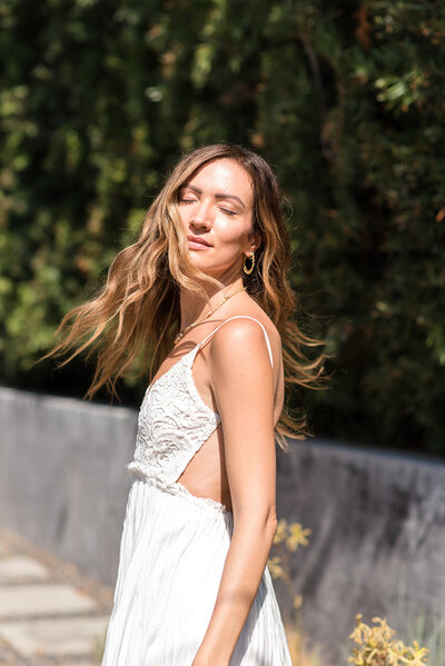melyssa griffin, standing outside, basking in the sun, hair flowing around her