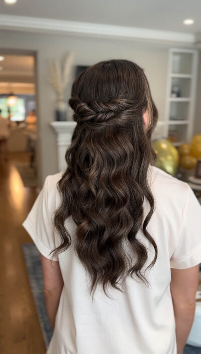 Bridesmaid with soft waves pulled into a half-up style — romantic and relaxed wedding day hair by Klover Beauty.