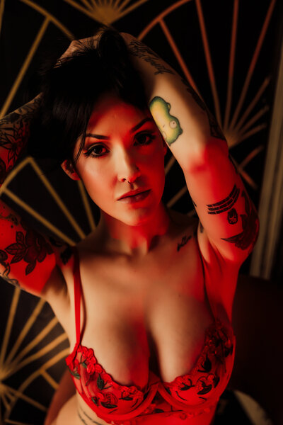 Boudoir photography woman in red lingerie standing by wall in Lubbock, Texas photographer in Amarillo TX
