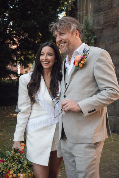 Wedding photographer captures couple taking a stroll hand in hand at their french chateau wedding.