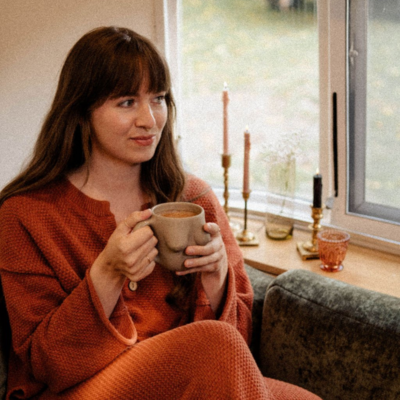 Adele Wimsett sits on a couch