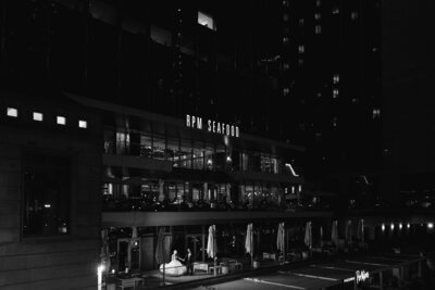 Bride and groom kissing at the Wrigley building for their photos by Chicago wedding photographer Winterlyn Stebner