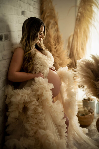 Expectant mother in KH Fashionhouse dress with pampas grass