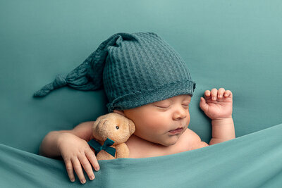 Newborn studio portraits in baby blue. Photographed by Brielle Pausma Photography in Indiana.