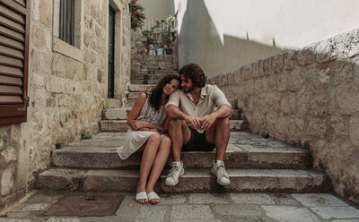 Couple in Dubrovnik Croatia  sitting on cobble stone steps