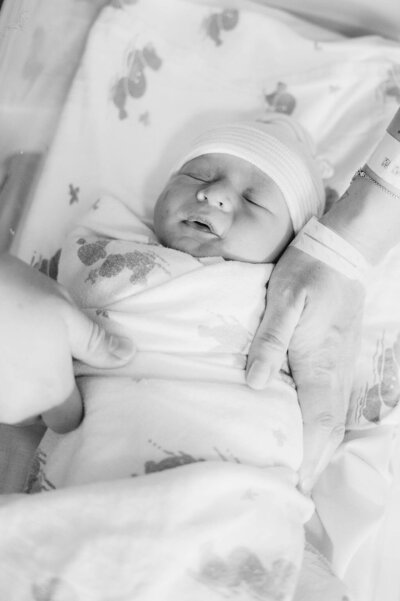 Best Fresh 48 newborn photographer in Massachusetts shot of a baby swaddled in the hospital bassinet