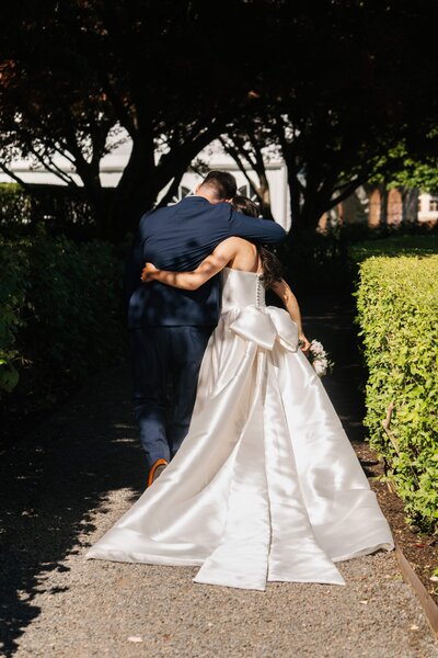couple hugging after getting married at turner hill in ipswich