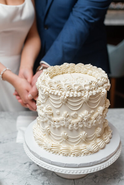 2 tiered wedding cake with purple florals from temi bakes