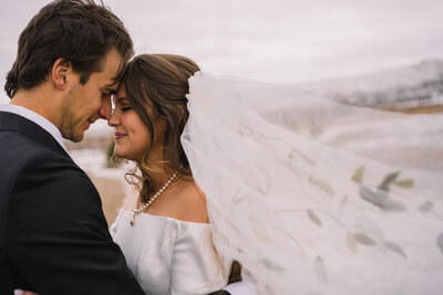 romantic photo of bride and groom nose to nose