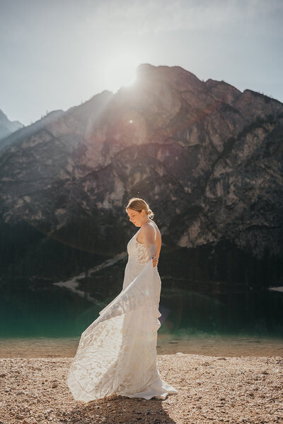 bride poses by lake
