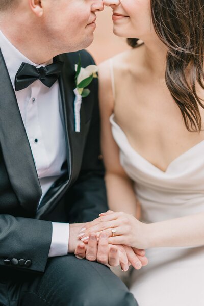 intimate moments of bride and groom facing each other and stacking their hands together in old town alexandria Northern Virginia