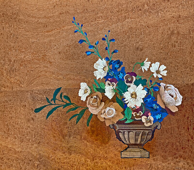 a colorful and intricate marquetry piece featuring summer flowers in a classic urn