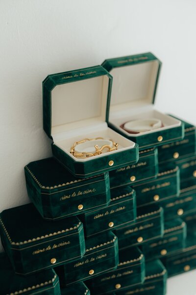 Stack of emerald green jewelry boxes with custom freehand hot foiling