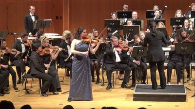 Dr. Erika Burns performing Tchaikovsky's violin concerto with orchestra.
