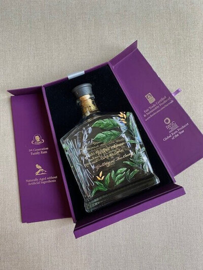 hand painted and engraved rum bottle at brand event in london