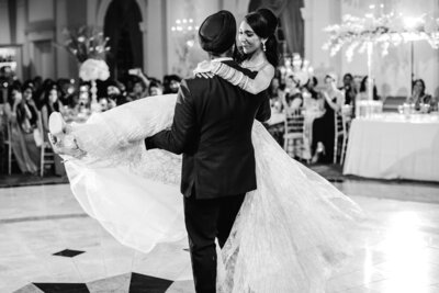 sikh groom carrying and spinning the bride during their first dance at the rockleigh country club in nj