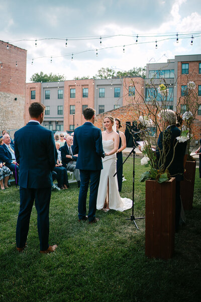 A couple holding hands as they say their vows during their wedding ceremony 