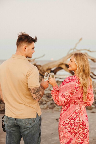 Couples Session at sunset on Jekyll Island at the beach while drinking champagne.