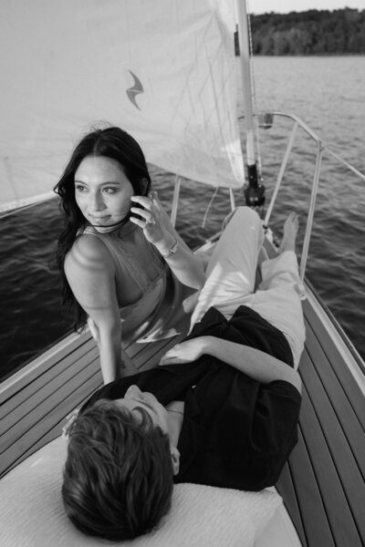 black and white image of couple on a sailboat on the lake in nashville