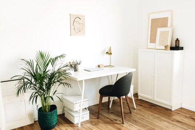 small home office desk with a plant