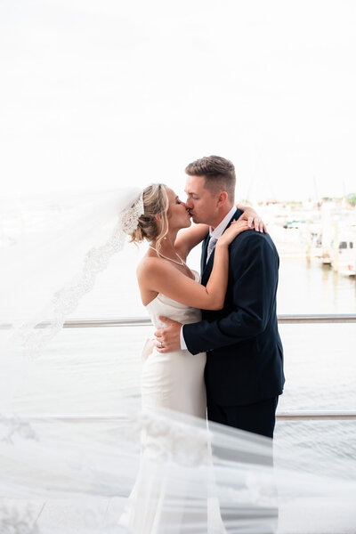 Bride and groom in from of ivy covered brick mansion