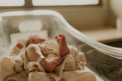 Parents admiring their newborn baby during Fresh 48 hospital photo session in Nashville