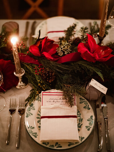 Christmas place setting with menu card and ivory place card attached to a Christmas ornament at Mayflower Inn