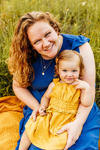 beautiful mama holding her baby girl as they both smile for their Door County photo session