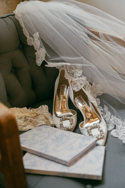 Detail photos of the bride's shoes, vow books and veil.